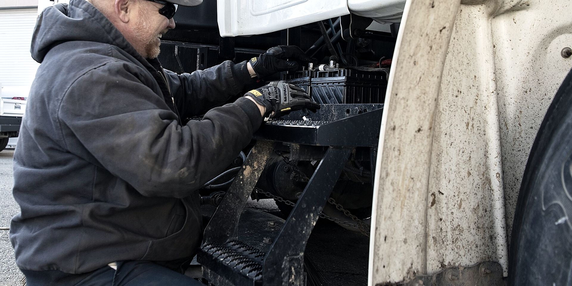 Technician working on a heavy truck in a maintenance bay